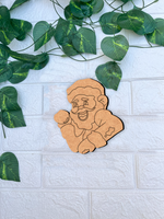 DIY MDF Santa Claus cutout for Christmas craft and painting mounted on a white textured brick wall