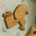 DIY MDF Santa Claus cutout holding gift for Christmas craft mounted on nursery call wall