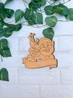 DIY MDF Santa and reindeer nameplate cutout with blank banner for personalization, Christmas craft base mounted on white bricks wall