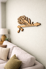  MDF DIY  wall art of a flute on a wall above a sofa with decorative pillows.