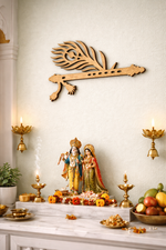 Decorative setup with statues, candles, and fruits on a white surface with a  MDF DIY  wall art piece.