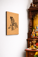 MDF DIY  wall art of a deity on a white wall next to a wooden cabinet with religious figurines.