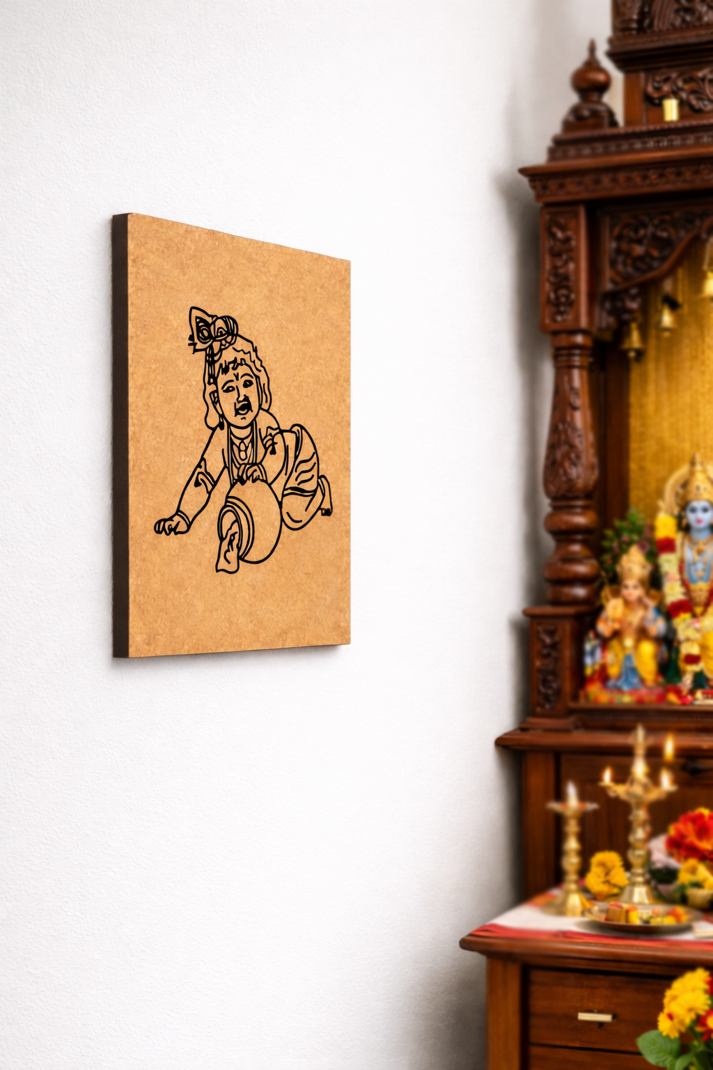 MDF DIY  wall art of a deity on a white wall next to a wooden cabinet with religious figurines.