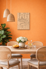 MDF DIY wall art Dining room with orange walls, wooden table, and wicker chairs.