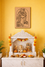 Decorative MDF DIY wall art  with statues and offerings against a yellow wall with a framed artwork.