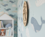 MDF DIY Wooden wall clock on a wall with whale patterns.