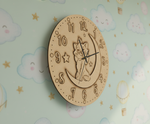 MDF DIY  wall clock with cat design on a pastel cloud-patterned background.