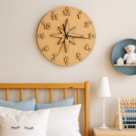 MDF DIY  wall clock on a wall above a bed with pillows and a lamp.