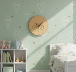 Children's room with a MDF DIY  clock on a green wall featuring hot air balloons and stars.