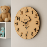 DIY MDF wall clock with cloud design on a light gray wall, featuring a teddy bear and toy robot in the background.