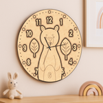 MDF DIY wall clock with bear design on a wall with toys around