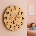 MDF DIY wall clock with butterfly and flower designs on a pink wall.
