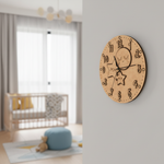 MDF DIY wall clock on a light gray wall with a blurred nursery in the background