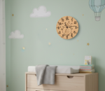 MDF DIY wall clock on a light green wall with cloud decorations in a nursery setting.