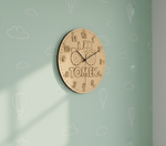 MDF DIY clock with 'Tomek' branding on a light green wall with cloud patterns