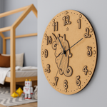 MDF DIY wall clock with unicorn design on a light gray wall, with a child's room in the background.