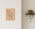 Minimalist line art of a woman with wings on a beige background, next to a plant on a shelf.