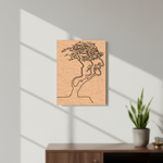 MDF DIY wall art with a minimalist design of a face and tree on a light gray wall.