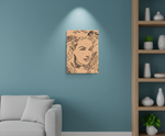 MDF DIY Canvas print of a stylized portrait on a teal wall above a gray sofa.