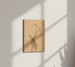 MDF DIY wall art with minimalist line drawing of a face and plant on a light background