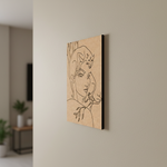 Abstract art piece on a beige wall with a blurred room background