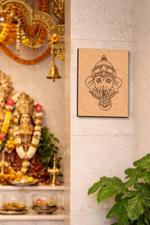 Decorative  MDF DIY wall art of a deity's face on a light-colored wall with religious statues and decorations.