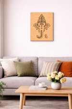 MDF DIY wall art of a deity figure on a white wall above a gray sofa with colorful cushions.