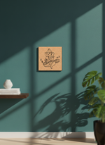 MDF DIY wall art of a deity figure on a teal wall with a plant and shelf in the foreground.