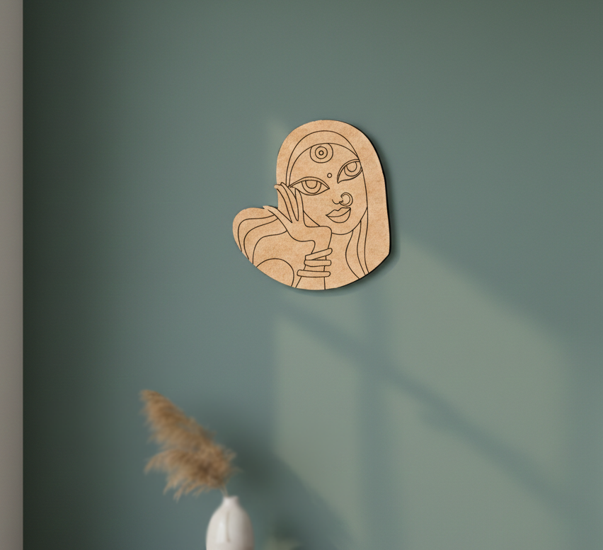 MDF DIY wall art of a stylized face on a green wall with a feather decoration.
