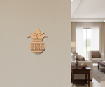 MDF DIY  kalash wall decor on a beige wall with a living room in the background