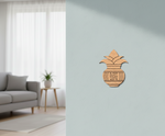 MDF DIY  kalash wall decor on a light blue wall with a living room in the background