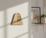 MDF DIY  wall art with a minimalist face design on a light wall.