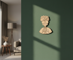 MDF DIY  wall art of a man's face on a green wall with a lamp and chair in the background.