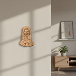 MDF DIY wall art of a face with hands pressed together on a beige wall.