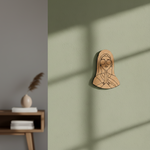 MDF DIY wall art of a praying figure on a green wall with a wooden shelf in the background.