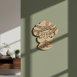 Decorative MDF DIY  wall art of a face with intricate patterns on a green wall.