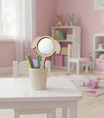 Pink and yellow dog-ear shaped MDF mirror kept in a pencil holder on a white kids’ table