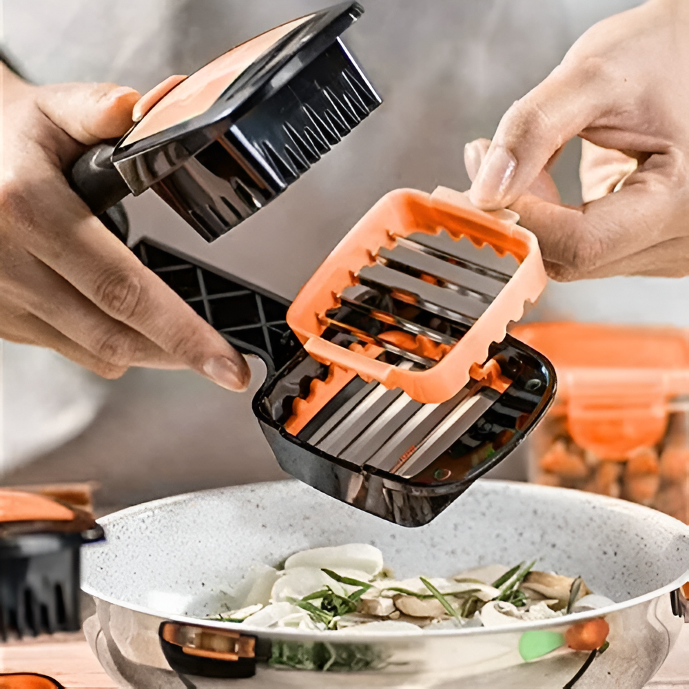 Handheld vegetable chopper with orange handle being used over a bowl of food.