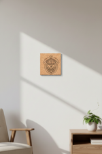 Wooden MDF DIY wall art piece on a white wall with a plant and chair in the foreground