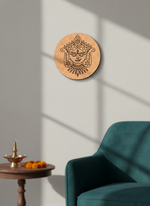 Decorative MDF DIY wall art with a face design on a wooden board in a room with a teal chair and small table.