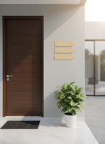 Modern house entrance with a wooden door, plant, and decorative wall art.