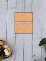 Two  MDF  board on a light gray wooden surface with floral decorations.