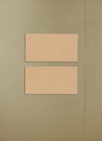 Two brown rectangular objects on a beige wall