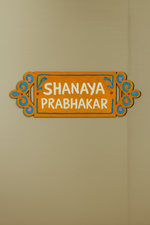 Decorative nameplate with 'SHANAYA PRABHAKAR' text on a beige background