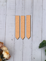 Three MDF board rectangular objects on a light wooden surface with floral and leaf decorations.