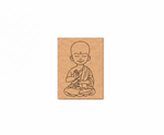MDF DIY  wall art of a monk in a meditative pose on a brown cardstock background