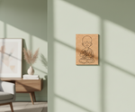 MDF DIY  wall art of a child in a meditative pose on a light green wall.