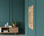 MDF DIY  wall art piece on a teal wall with a wooden cabinet and plant below.