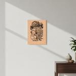 Decorative peacock MDF DIY wall art on a light gray wall with a wooden side table and plant in the corner.