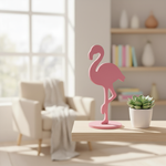 Pink MDF flamingo décor on wooden shelf with bright sunlight and pastel decor
